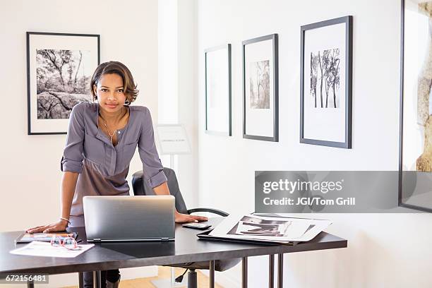 black woman using laptop in art gallery office - woman business desk front laptop office bildbanksfoton och bilder