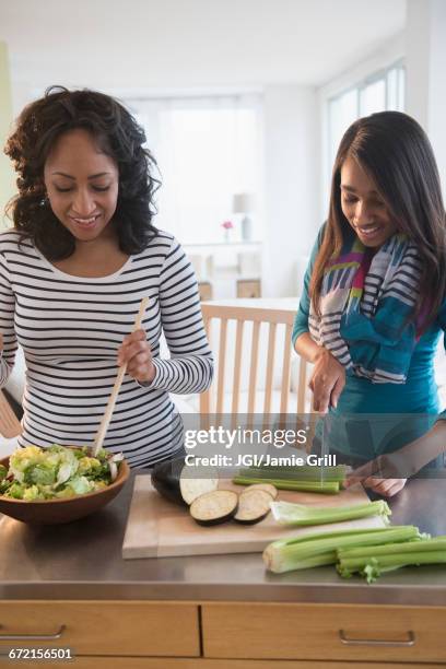 mother and daughter chopping vegetables for salad - teenager cooking stock pictures, royalty-free photos & images