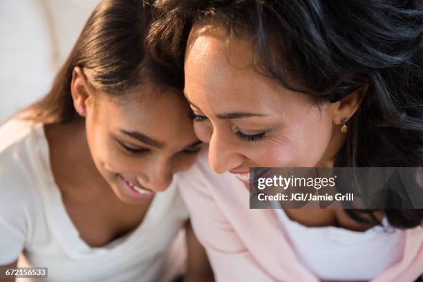 mother and daughter laughing - two young arabic children only indoor portrait stock-fotos und bilder