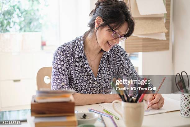 hispanic woman sketching in home office - adult coloring stock pictures, royalty-free photos & images