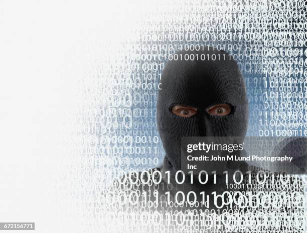 hacker wearing mask in binary code - cyber war stock pictures, royalty-free photos & images