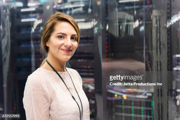 caucasian technician posing in computer server room - good technology inc stock pictures, royalty-free photos & images