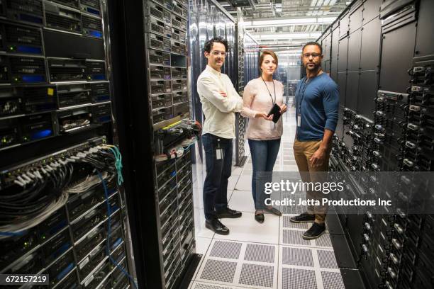 technicians holding digital tablet in computer server room - good technology inc stock pictures, royalty-free photos & images