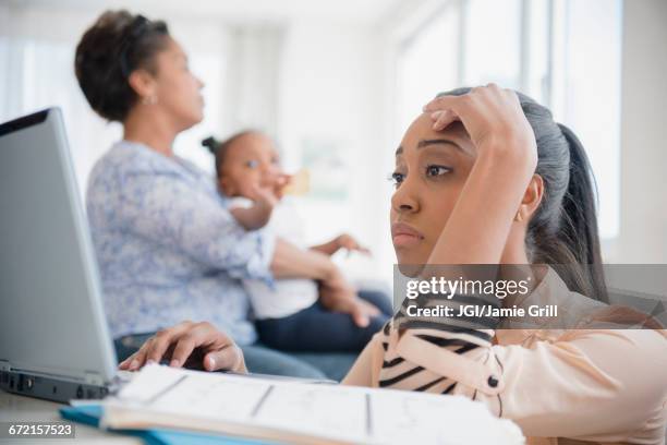 stressed black woman paying bills using laptop - grandma invoice stock pictures, royalty-free photos & images