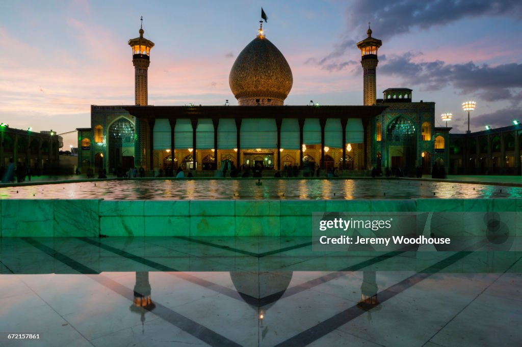 Reflection of Holy Shrine of Shah-e-Cheragh at dusk, Shiraz, Iran, 