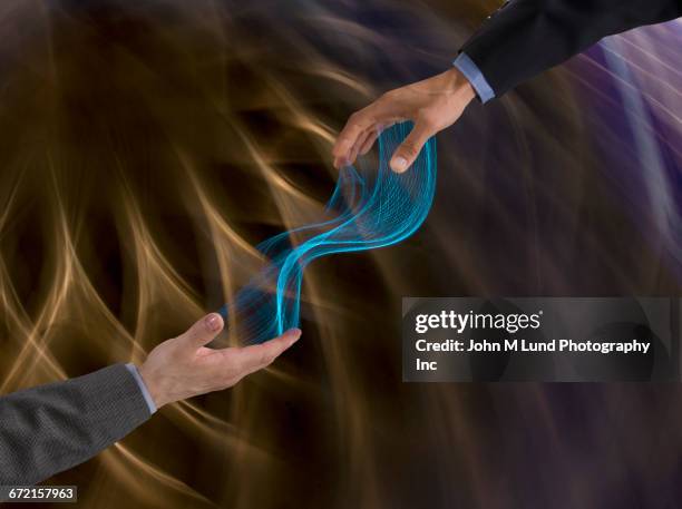 energy flowing between hands of businessmen - handshake abstract stock pictures, royalty-free photos & images