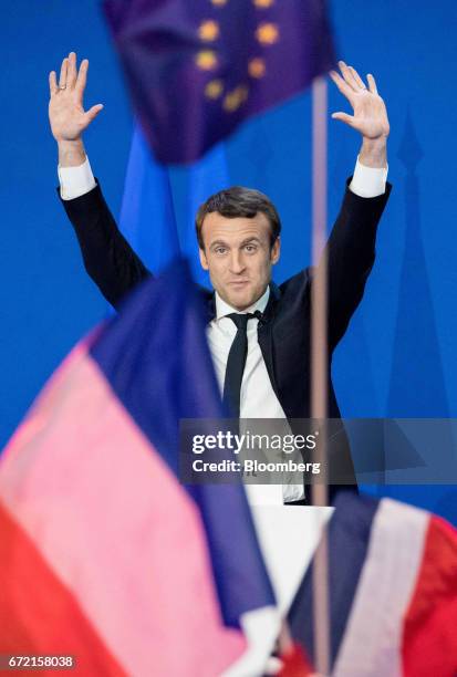 Emmanuel Macron, France's independent presidential candidate, waves to supporters before delivering a speech after the first round vote projections...