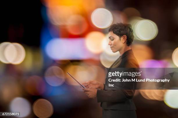 mixed race businesswoman using digital tablet with multicolor circles - good technology inc stock pictures, royalty-free photos & images