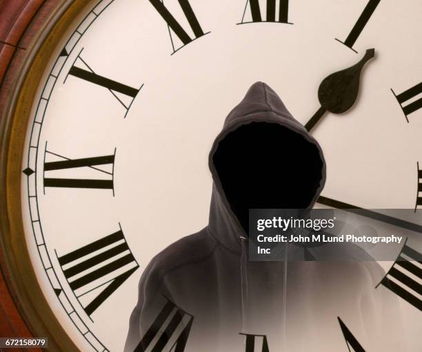 double exposure of mysterious hoodie and clock - ominous clock stock pictures, royalty-free photos & images