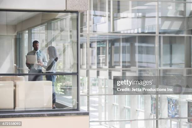 black business people using laptop in corner office - corner office stock pictures, royalty-free photos & images