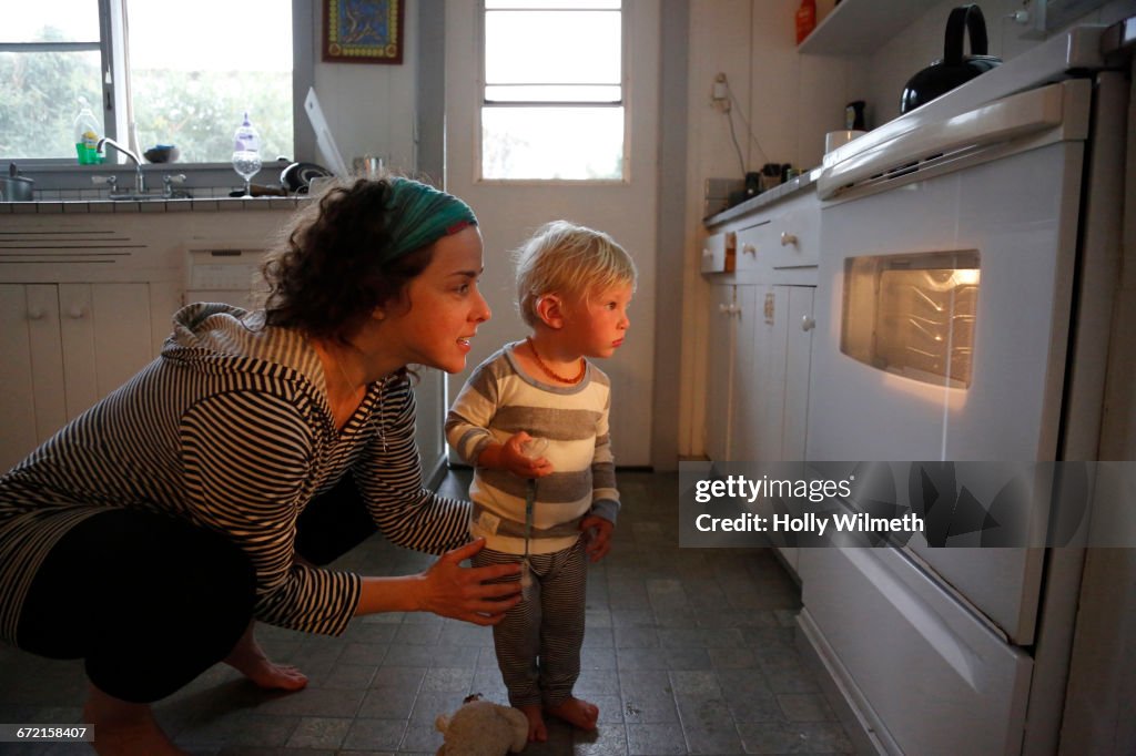 Mother and son looking in oven window