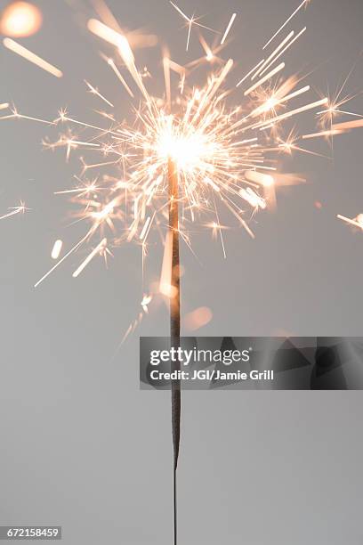 sparks on burning sparkler - sparkler imagens e fotografias de stock