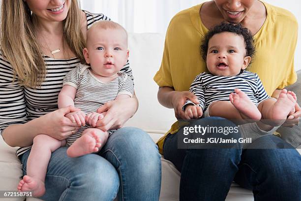 mothers holding baby sons in laps - play date imagens e fotografias de stock