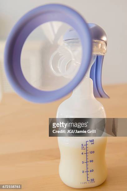 breast pump with breast milk - milk pumping ストックフォトと画像