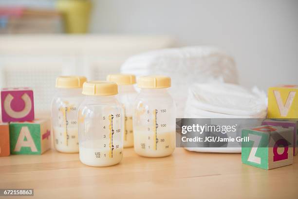 blocks, diapers and bottles of breast milk - milk pumping stockfoto's en -beelden