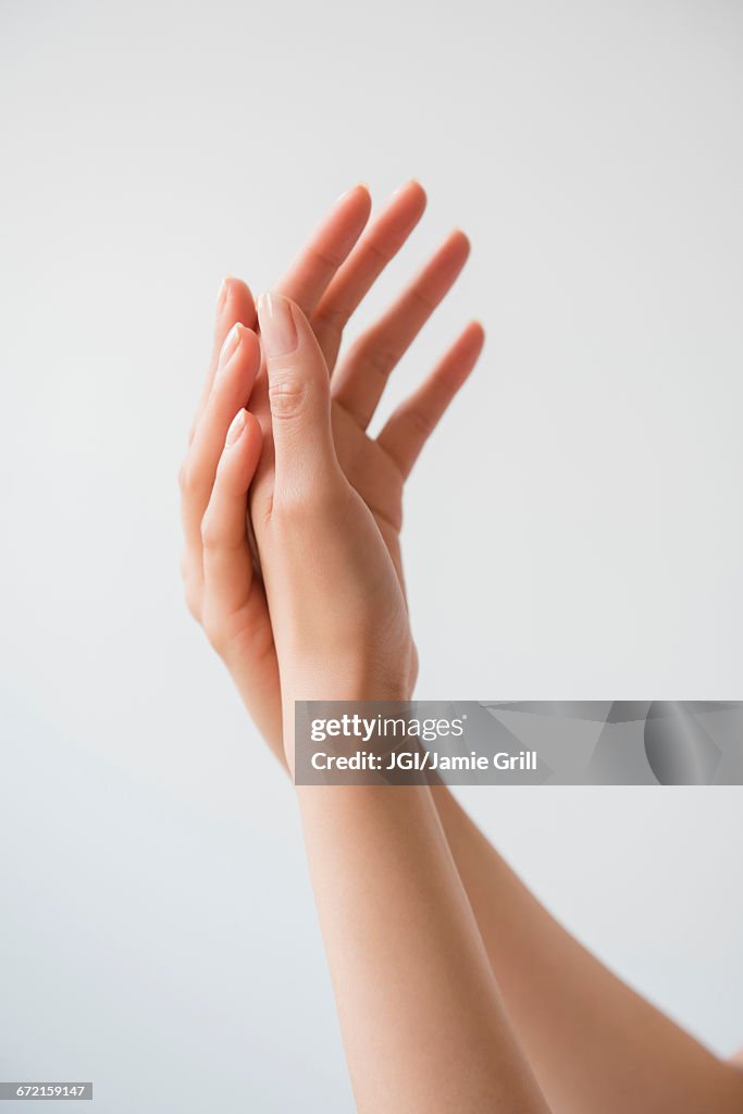 Hispanic woman rubbing hands