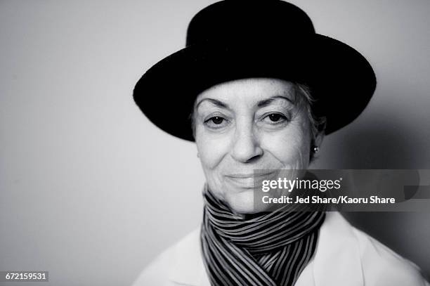 smiling caucasian woman wearing scarf and hat - black and white fotos stock-fotos und bilder