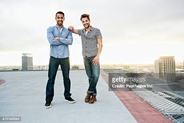 stylish men posing on urban rooftop - two people standing stock pictures, royalty-free photos & images