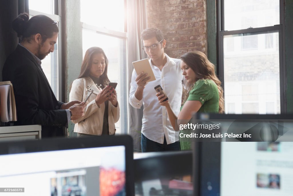 Customers Using Tablets Business People Using Cell Phones And Digital Tablets In Office High ...