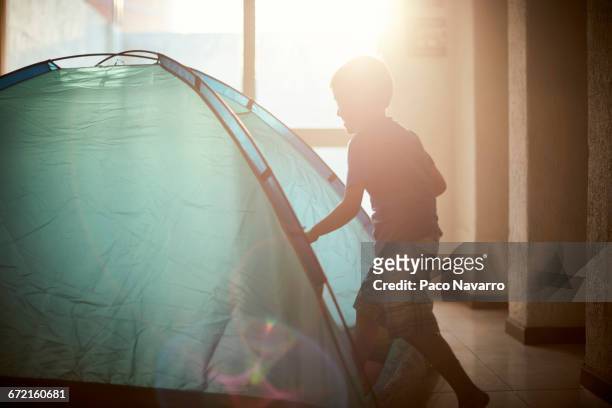 hispanic boy camping in tent indoors - zapopan stock pictures, royalty-free photos & images