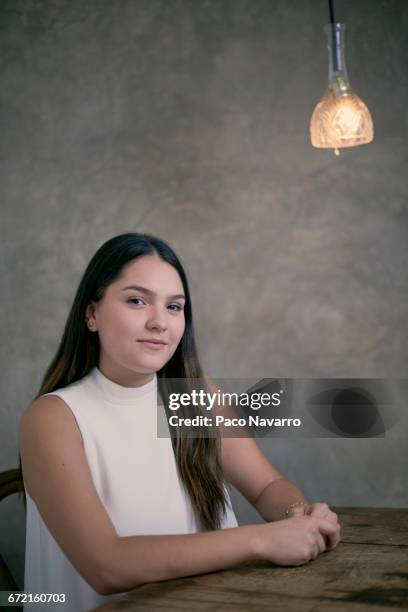 smiling hispanic woman sitting at wooden table - zapopan stock pictures, royalty-free photos & images