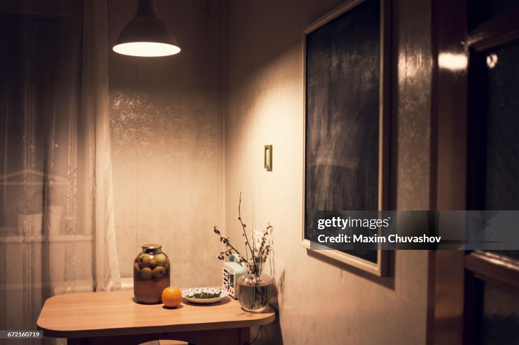 Food on corner table in kitchen with blackboard