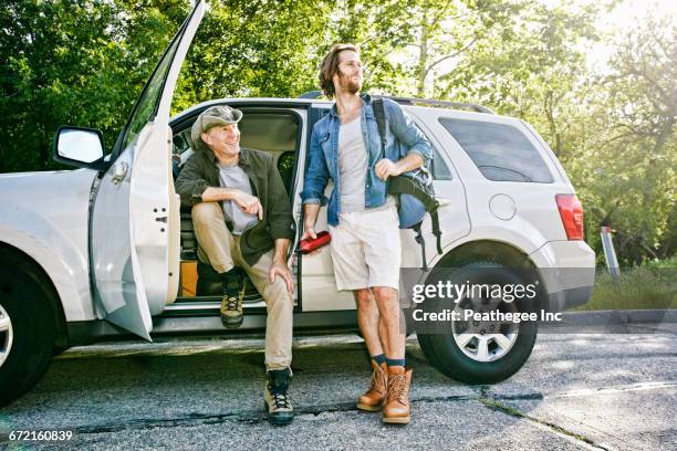 caucasian sitting and standing at car - car isolated doors open stock pictures, royalty-free photos & images