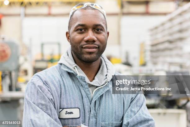 smiling worker in factory - blue collar portrait stock pictures, royalty-free photos & images