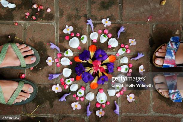 feet of woman near arranged flowers - guatemala family stock pictures, royalty-free photos & images