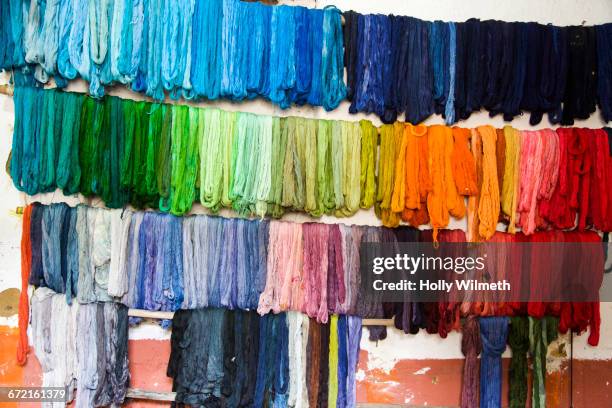 dyed fabric hanging on wall - färbemittel stock-fotos und bilder