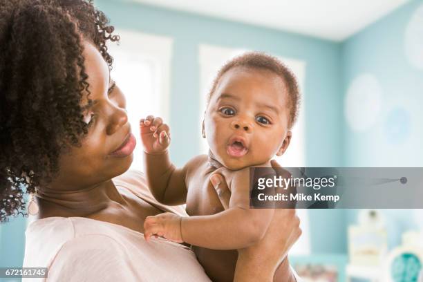 black mother holding baby son - lehi stock pictures, royalty-free photos & images