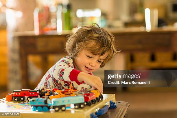 caucasian boy playing with toy trains - toddler imagination stock pictures, royalty-free photos & images