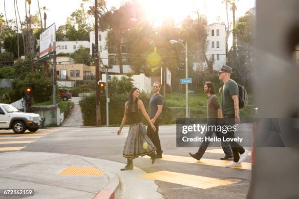 friends walking in city crosswalk - la four stock pictures, royalty-free photos & images