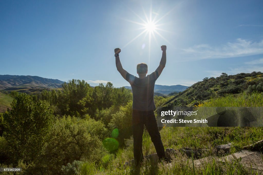 Caucasian man celebrating on mountain