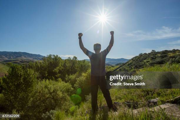 caucasian man celebrating on mountain - tensed idaho stock pictures, royalty-free photos & images