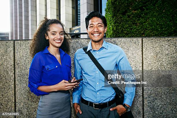 smiling businesspeople posing outdoors - messenger bag stock pictures, royalty-free photos & images