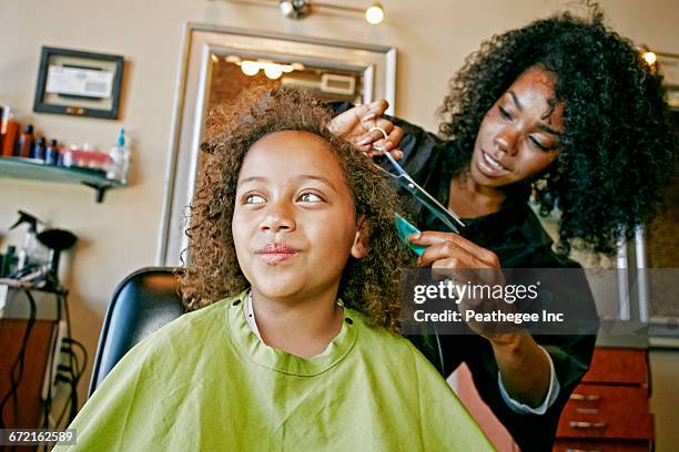 smiling hairdresser and customer in hair salon - hairdressers black woman stockfoto's en -beelden