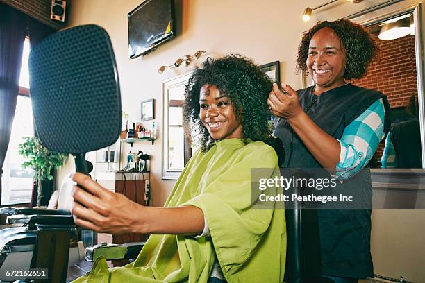 smiling hairdresser and customer in hair salon - african american hair salon stock pictures, royalty-free photos & images