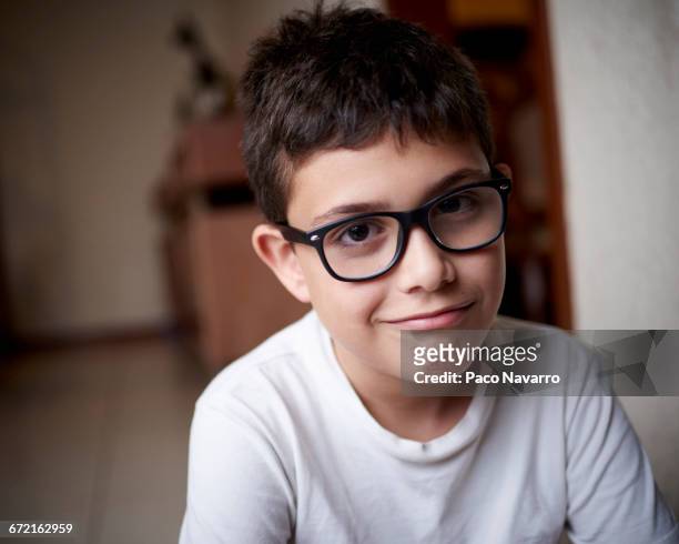 smirking hispanic boy wearing eyeglasses - smirking stock pictures, royalty-free photos & images