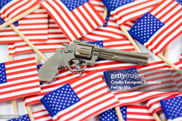 in the united states anyone can shoot a firearm - american flag gun stock pictures, royalty-free photos & images