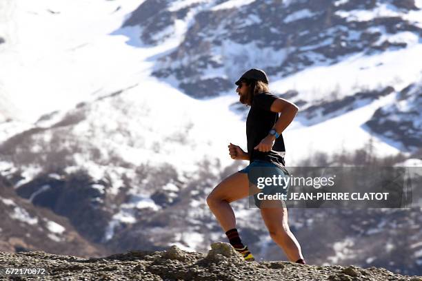 Ultra-trail runner Anton Krupicka runs during a trainning session on April 14, 2017 in Les Houches by the Mont Blanc mountain, in the Alps. - He runs...