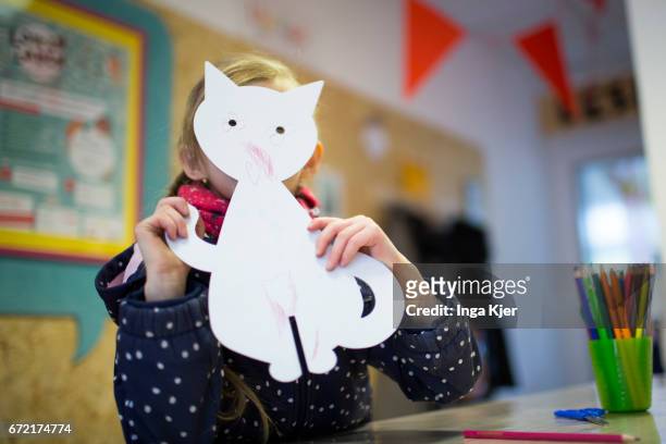 Berlin, Germany A girl holds up a cardboard cat in a social Pop-up-Store on April 20, 2017 in Berlin, Germany on April 20, 2017 in Berlin, Germany....