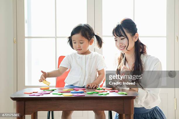 mother and daughter playing with alphabet toy - 日本人　英語 ストックフォ��トと画像