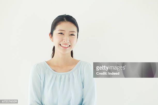 portrait of smiling young woman - japanese woman stock pictures, royalty-free photos & images