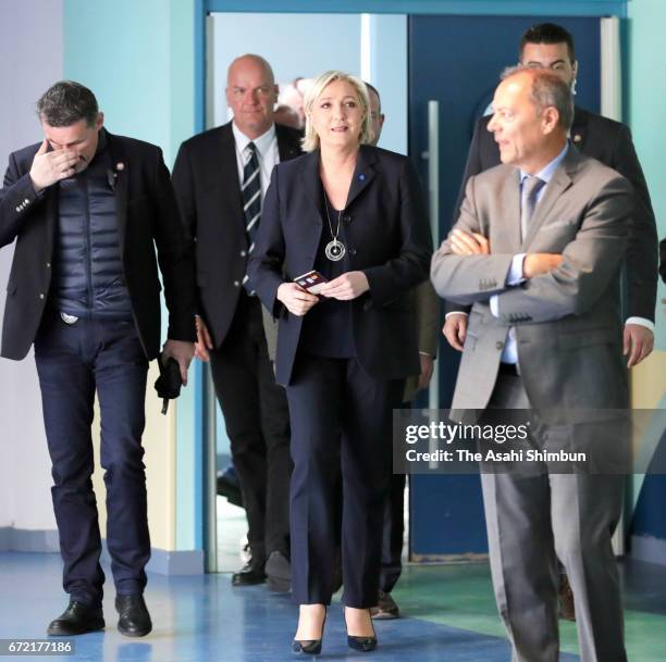 National Front Leader Marine Le Pen arrives to cast her vote for the French elections into the ballot box at a polling station on April 23, 2017 in...