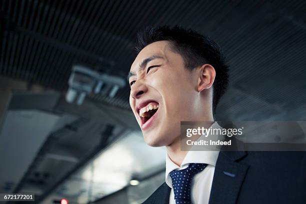 young businessman cheering and shouting - 叫ぶ ストックフォトと画像