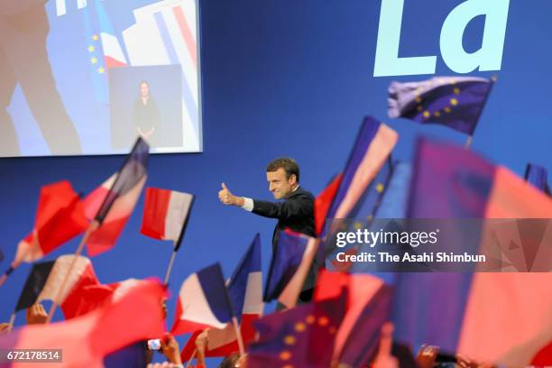 Founder and Leader of the political movement 'En Marche !' Emmanuel Macron thumbs up to his supporters after winning the lead percentage of votes in...