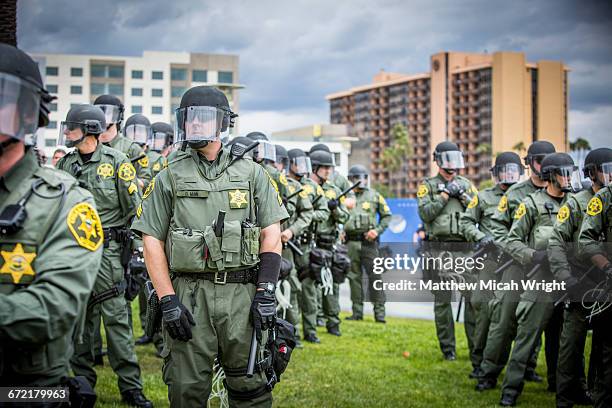 protestors and police presence at a trump rally. - anaheim california stock pictures, royalty-free photos & images