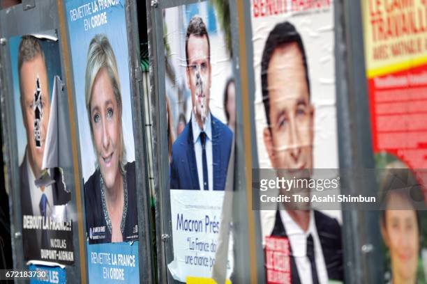 Posters of presidential candidates are seen outside a polling station on April 23, 2017 in Henin Beaumont, France. The country will vote in a second...