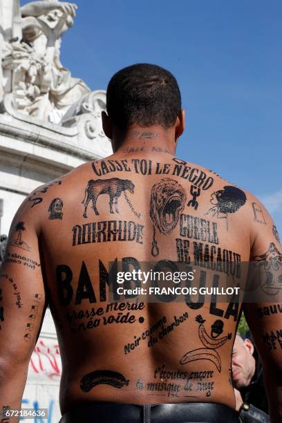 Man with his body covered with racist insults poses during an event organized by the Conseil Representatif des Associations Noires de France - CRAN...